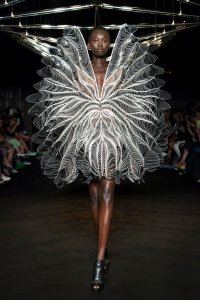 Iris van Herpen Syntopia collection dress inspired by bird flight and kinetic installations, crafted with laser-cut organza and intricate weaving.