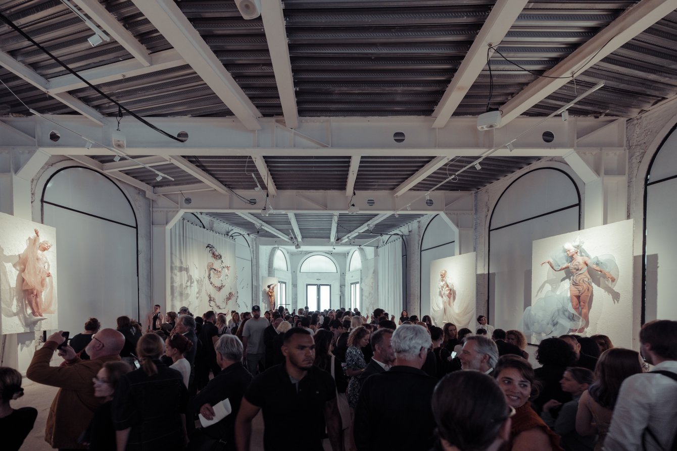 Iris van Herpen Hybrid Show couture design exploring the fusion of human and digital identities, with sculptural silhouettes and fluid futuristic details.