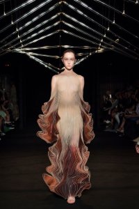 Iris van Herpen Syntopia collection dress inspired by bird flight and kinetic installations, crafted with laser-cut organza and intricate weaving.
