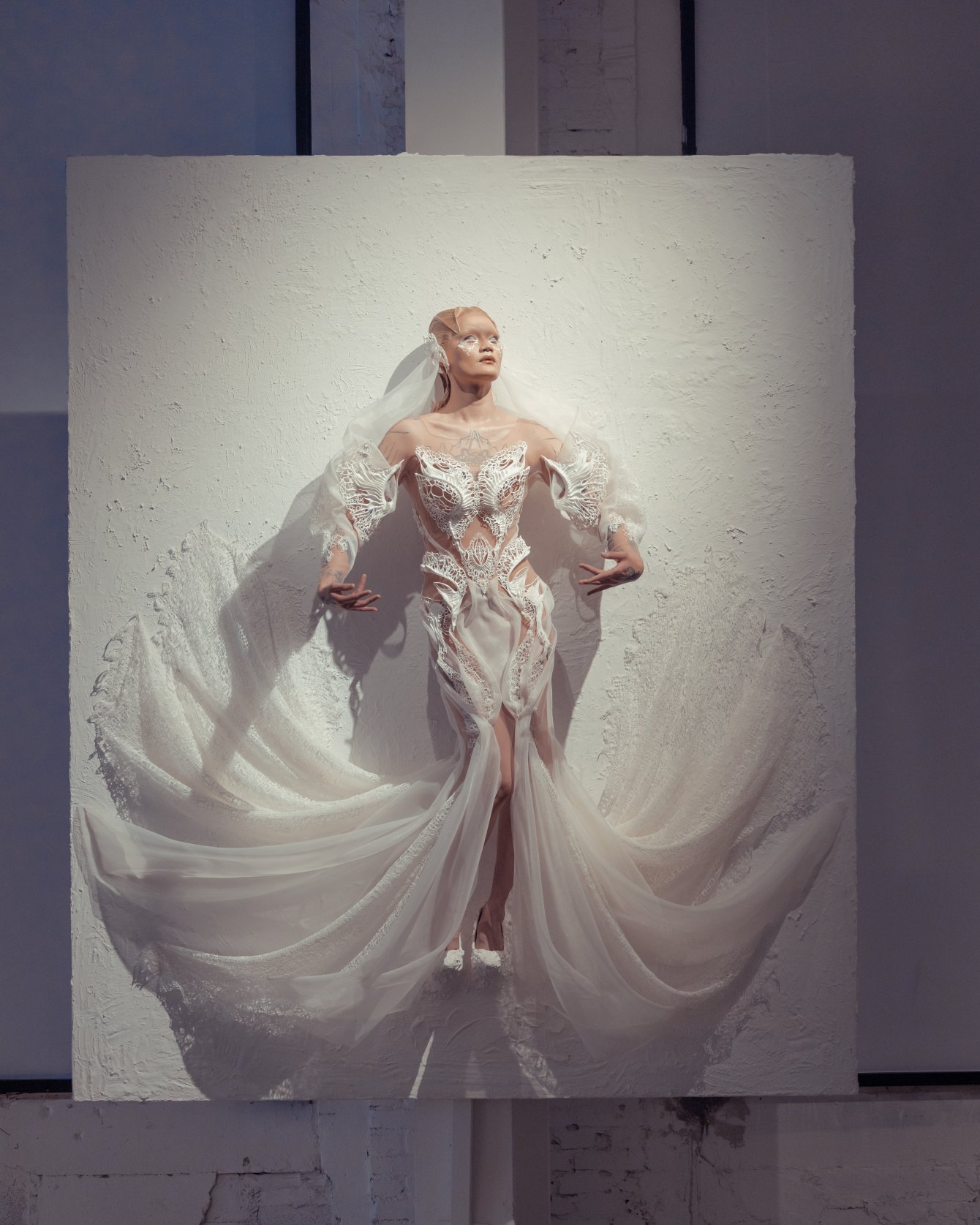 Iris van Herpen Hybrid Show couture design exploring the fusion of human and digital identities, with sculptural silhouettes and fluid futuristic details.